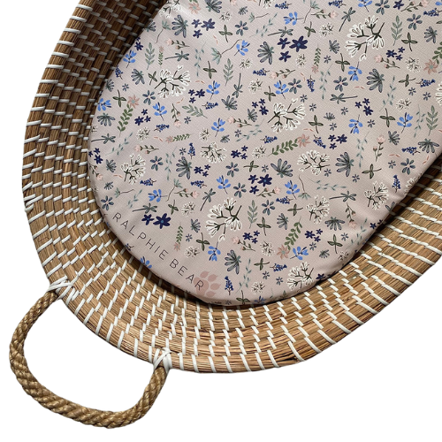 Round floral cushion with 'Ralphie Bear' branding on a woven basket