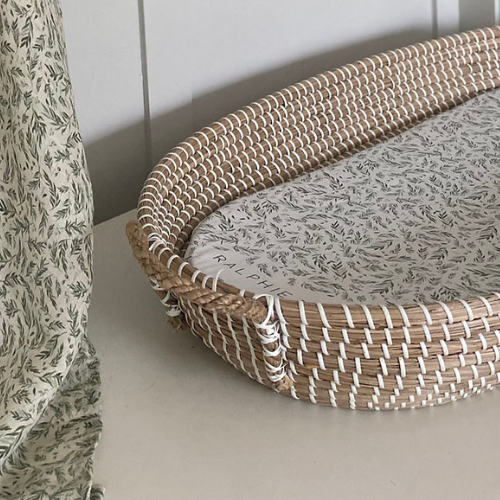 Woven basket with floral fabric lining on a neutral background