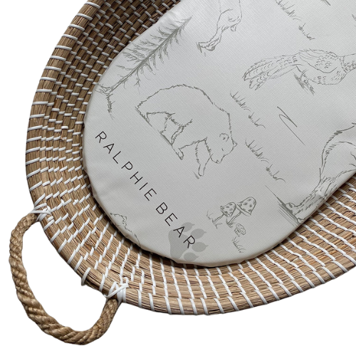 Round cushion with bear design and 'Ralphie Bear' branding on a woven mat.