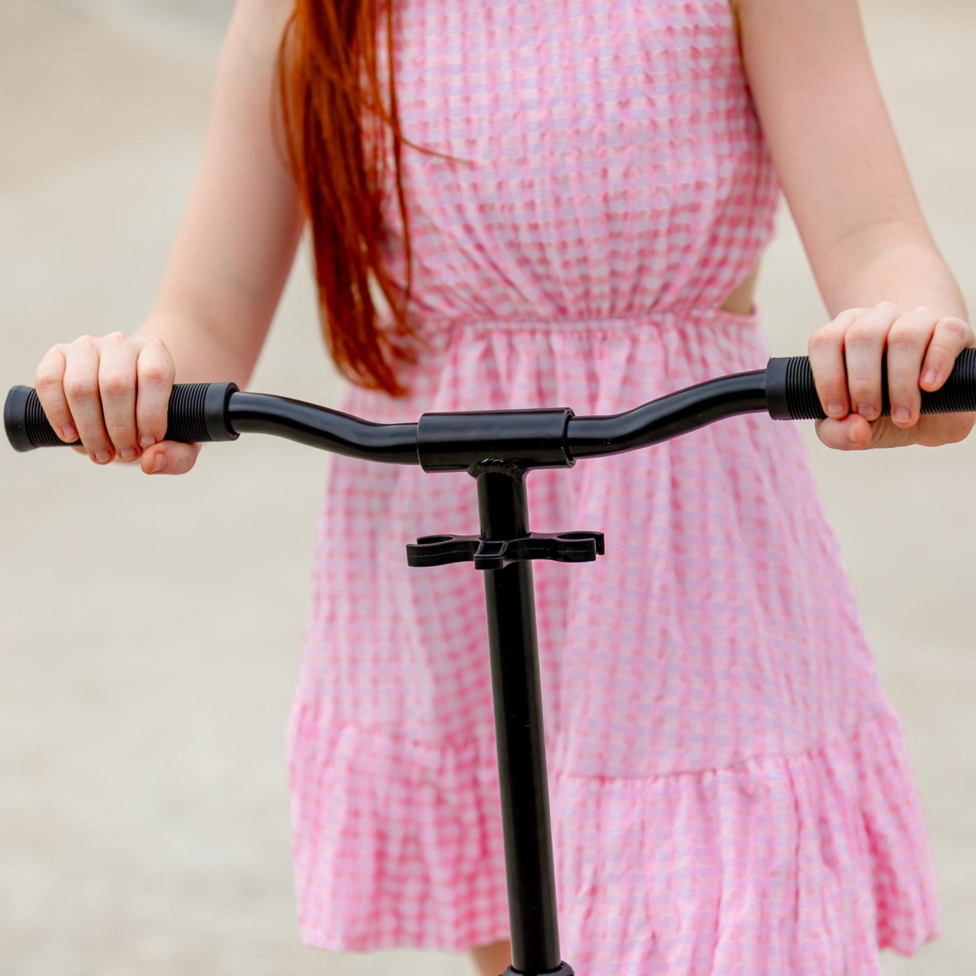 Person holding a scooter with a plain background