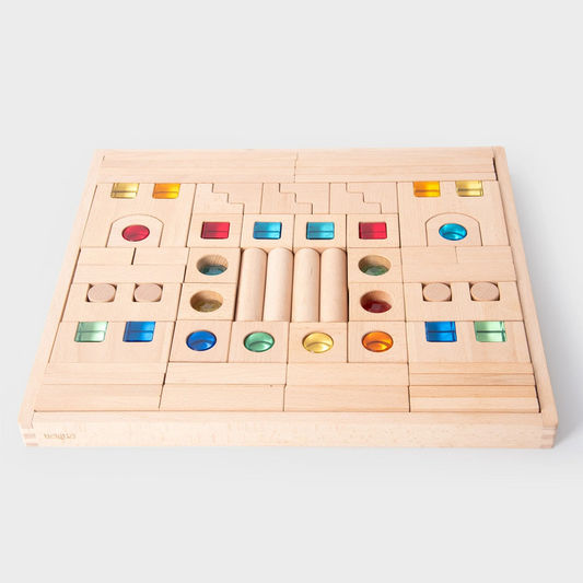 Wooden blocks in a tray. some blocks have gems within