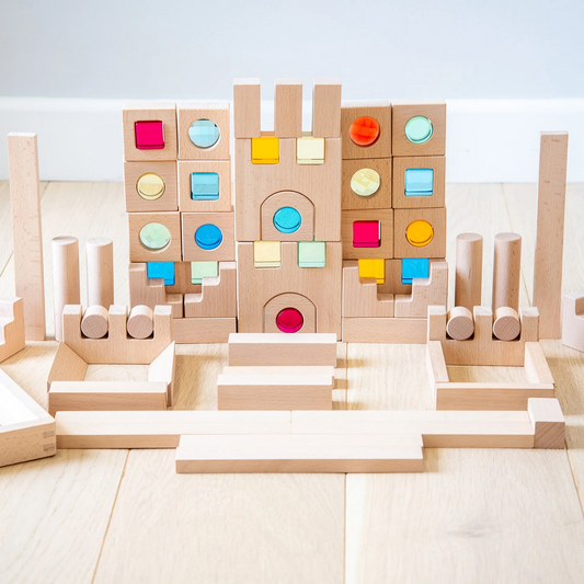 Colourful  gem wooden building blocks on a light wooden floor