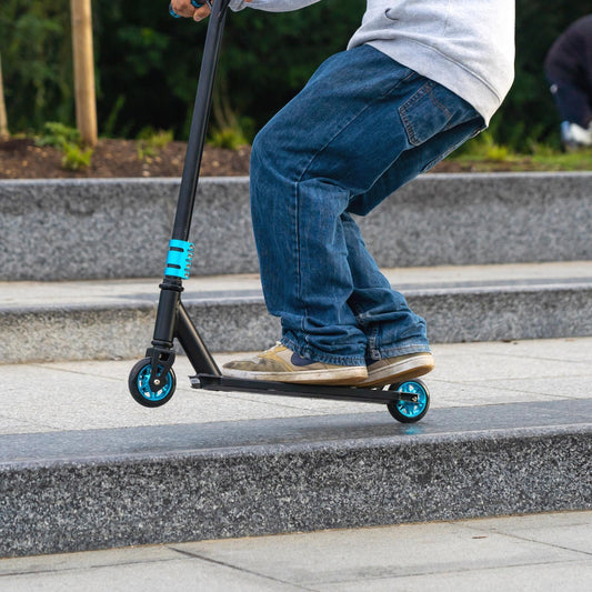 Person riding a scooter on a set of stairs outdoors