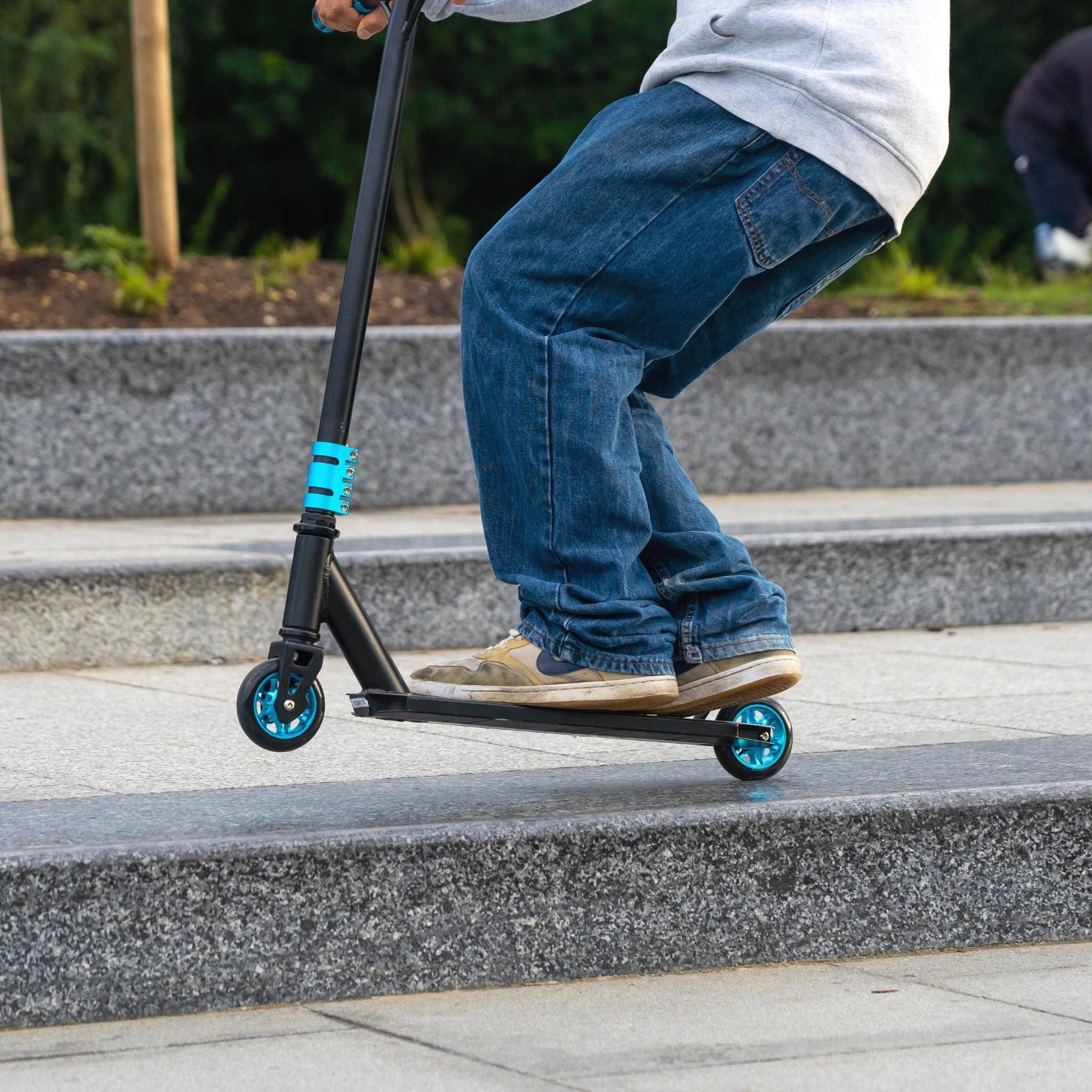 Person riding a scooter on a set of stairs outdoors