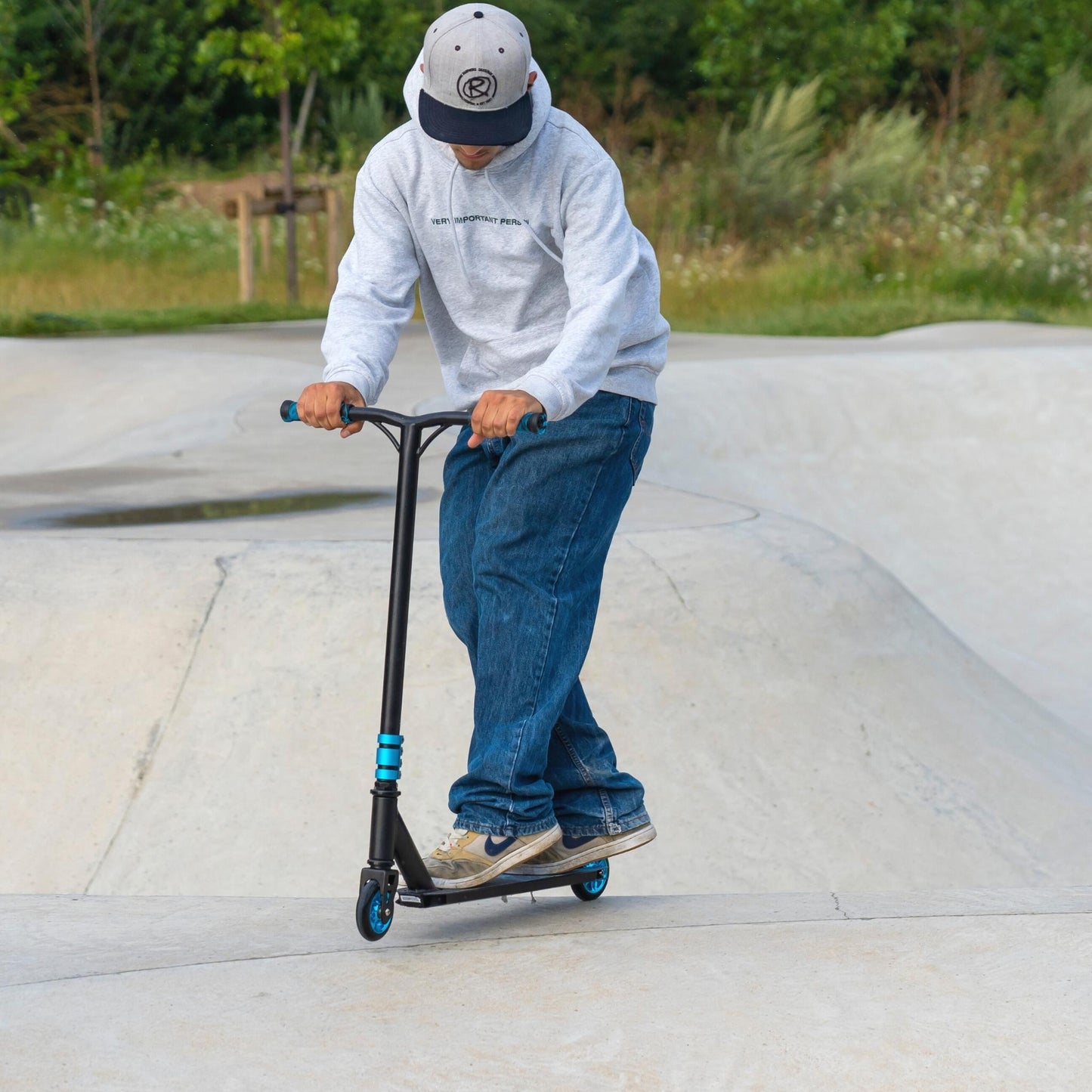 Person riding a scooter at a skate park