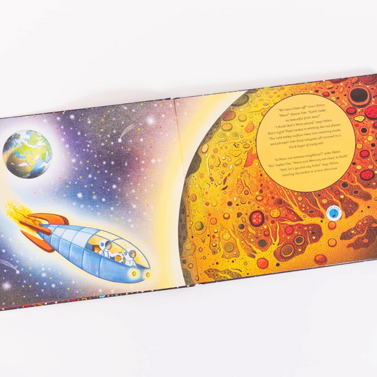 Open book showing space-themed illustrations with a rocket and planets.