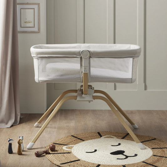 Baby crib with wooden base in a room setting