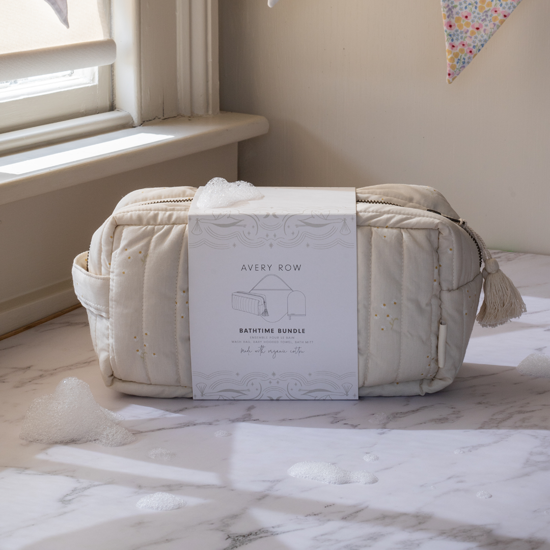 Bathtime bundle with packaging on a marble surface near a window