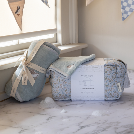 Baby blankets with packaging on a marble surface near a window