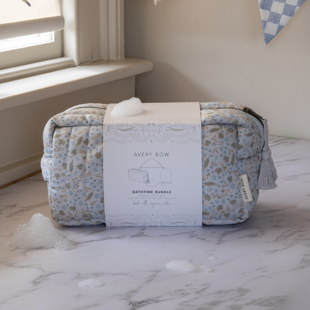 Baby product bundle with floral-patterned bag and box on a marble surface