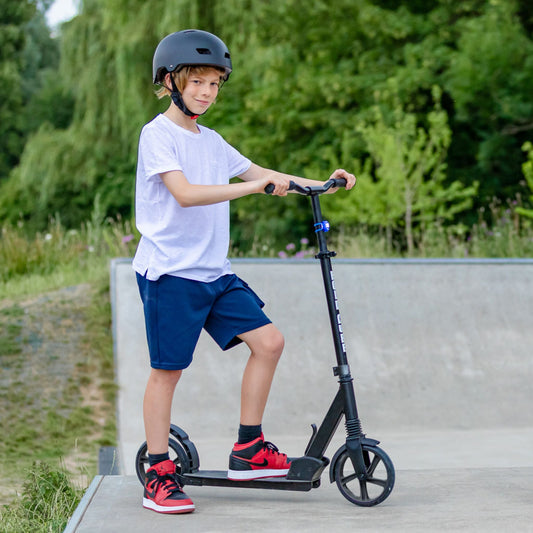 Child riding a scooter with a helmet in an outdoor setting