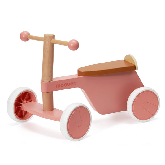 Pink and wooden tricycle with 'moover' branding on a white background