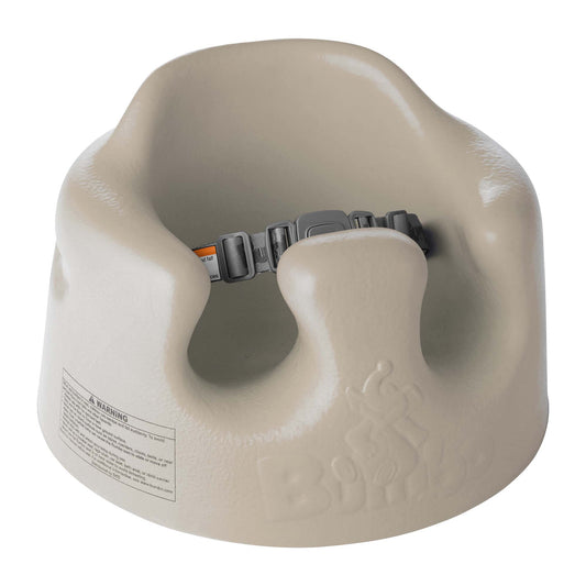 Beige baby seat with a safety belt on a white background