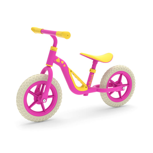 Pink and yellow balance bike on a white background