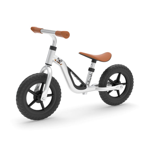 White balance bike with brown handlebar and seat on a white background