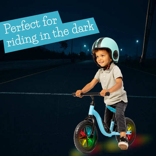 Child riding a balance bike at night with text 'Perfect for riding in the dark'.