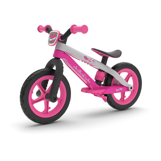 Pink and gray balance bike on a white background