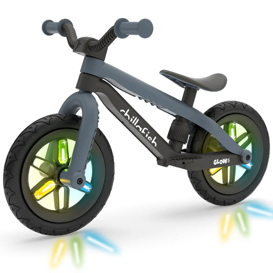 Children's balance bike with colorful wheels on a white background