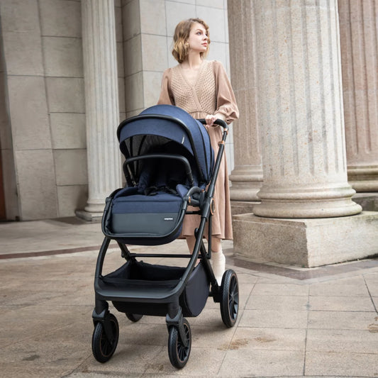 Woman pushing a blue stroller in an urban setting with classical architecture.