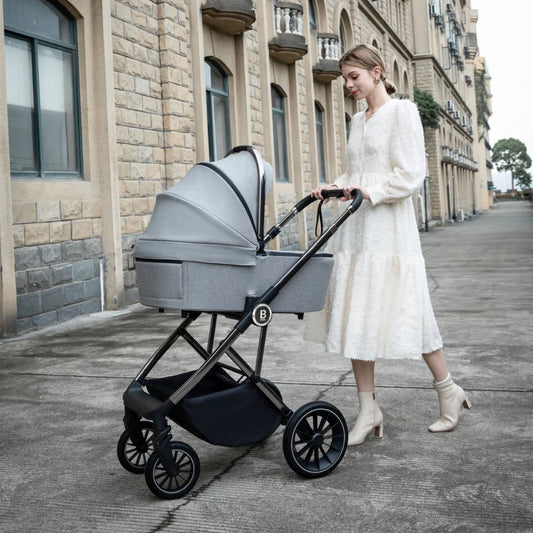 Woman pushing a stroller with a baby bassinet on a city street.