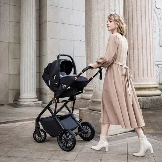 Woman pushing a black stroller in an urban setting with classical architecture.