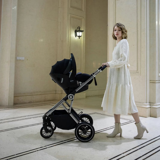 Woman in a white dress pushing a black stroller in an elegant hallway.