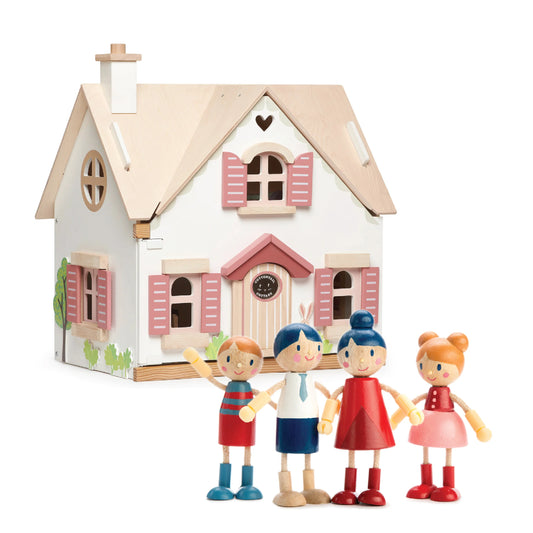 Toy house with four colorful toy figures in front on a white background