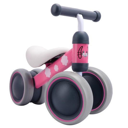 Pink and gray balance bike with paw print design on a white background