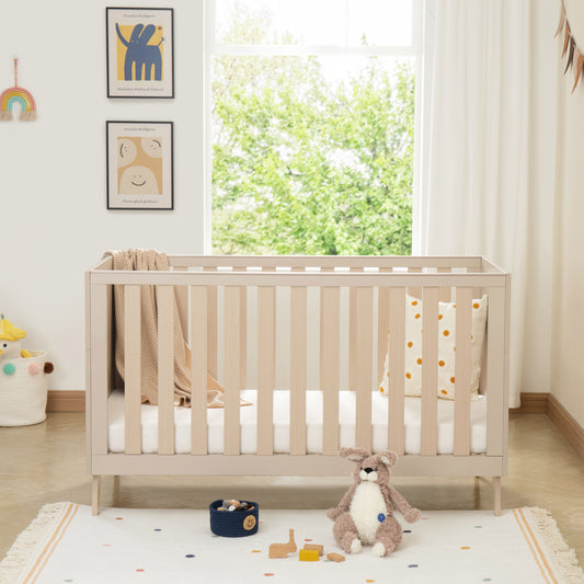 Nursery room with a cot, toys, and decorative elements.
