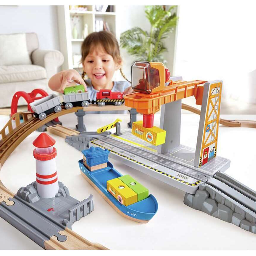 Train toy set up with a child playing with it