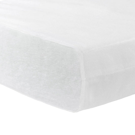 White fitted sheet on a bed with a plain background