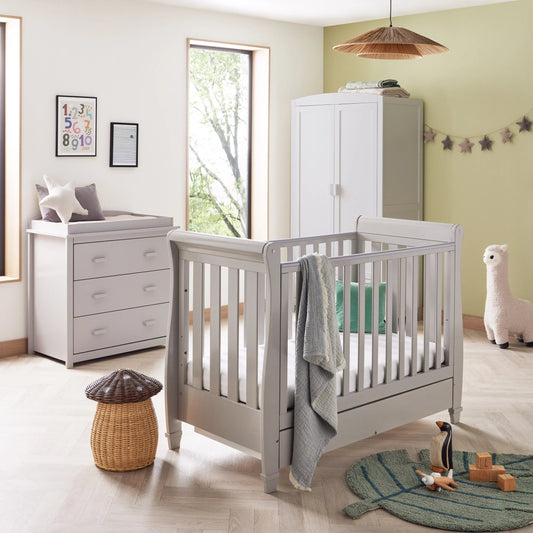 Children's room with a crib, changing table, and toys.