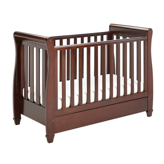 Wooden crib with white mattress on a white background