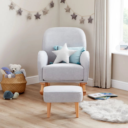 Gray armchair with a star-shaped pillow in a nursery setting