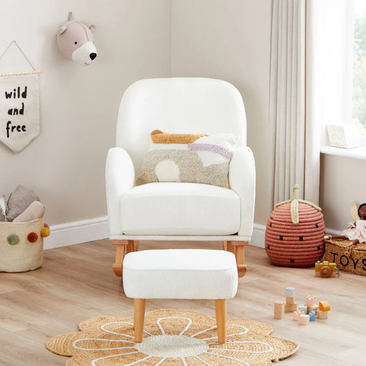 White armchair with ottoman in a child's playroom with toys and decor.