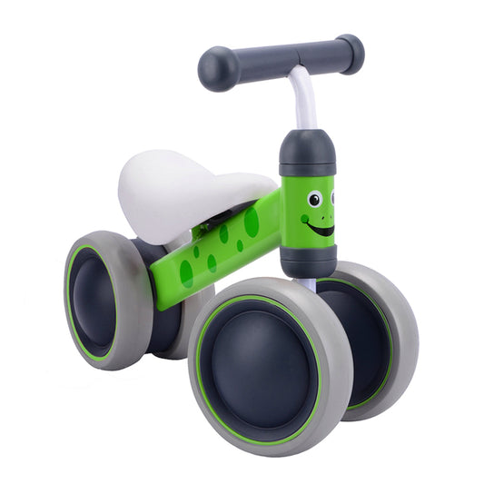 Children's balance bike with green frame and gray wheels on a white background