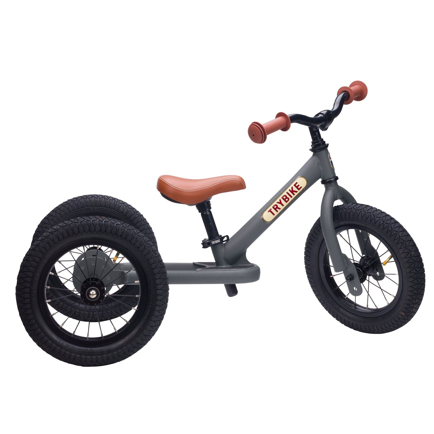 Children's tricycle with brown seat and handlebar on a white background