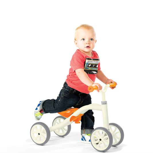 Child riding a tricycle on a white background