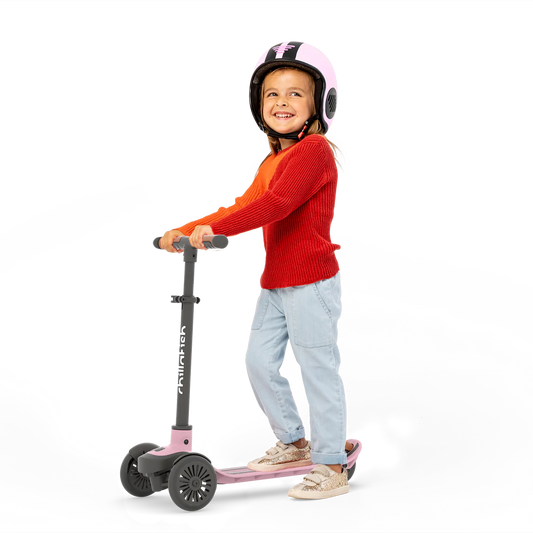 Child riding a scooter with a helmet on a white background
