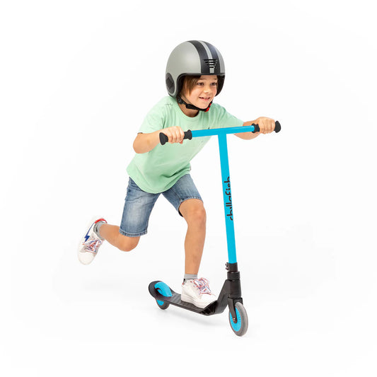 Child riding a blue scooter with a helmet on a white background