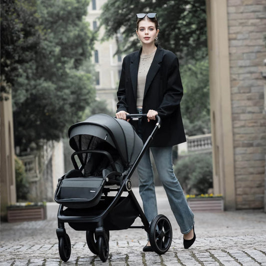 Woman pushing a black stroller in an urban setting