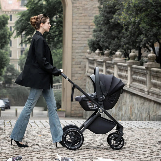 Woman pushing a black stroller in an urban setting