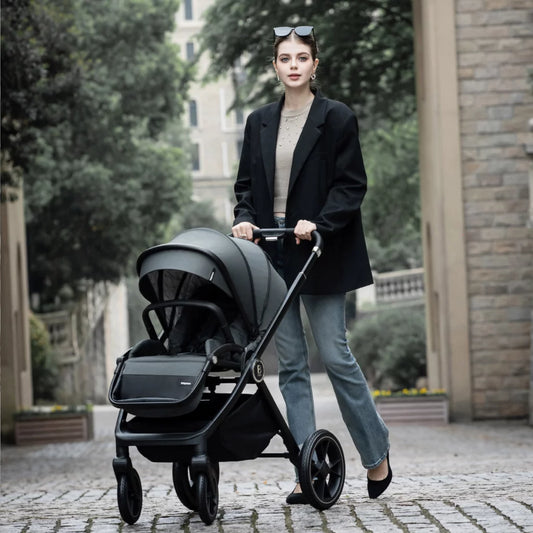 Woman pushing a black stroller in an urban setting