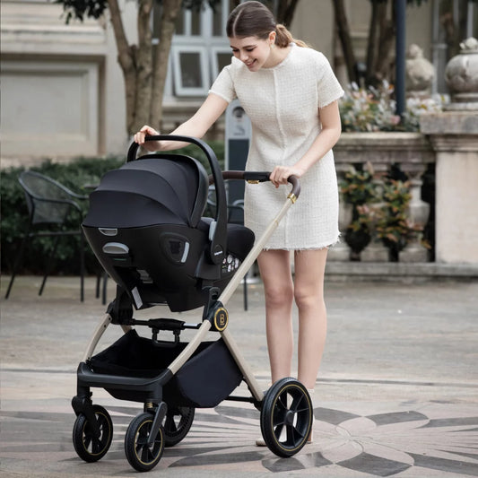 Woman pushing a stroller with a baby seat in an outdoor setting