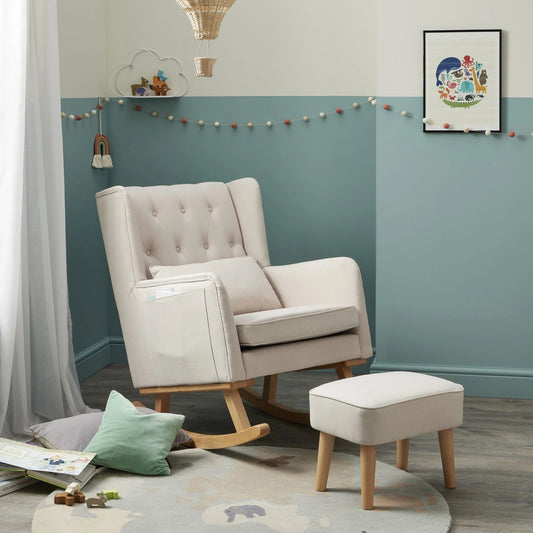 Beige armchair and ottoman in a room with teal walls and decorative elements.
