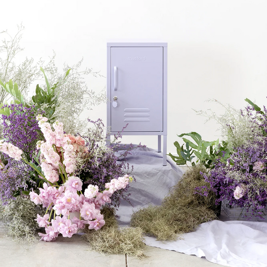 Small purple locker with floral arrangements on a white background