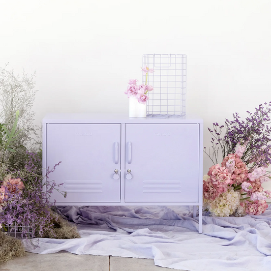 Light purple cabinet with floral decorations on a white background
