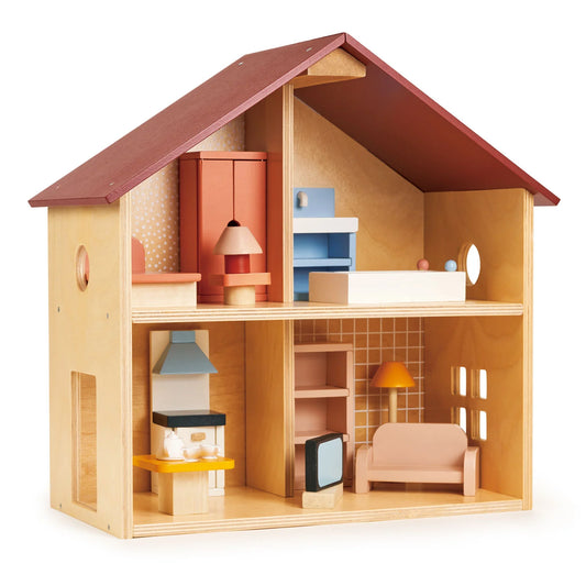 Wooden dollhouse with various furniture pieces on a white background