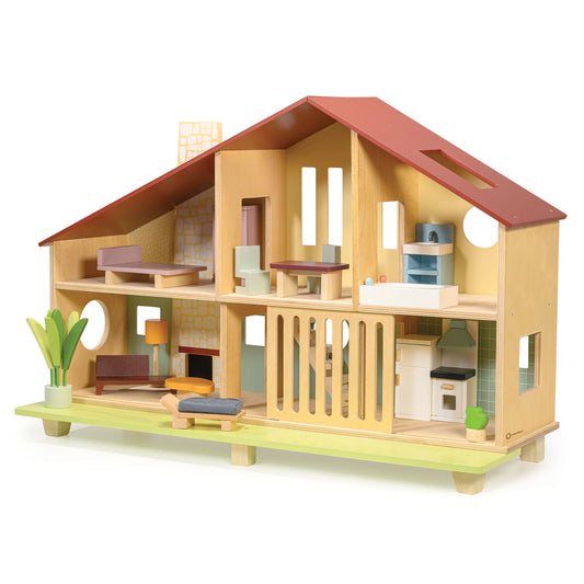 Wooden dollhouse with furniture on a white background