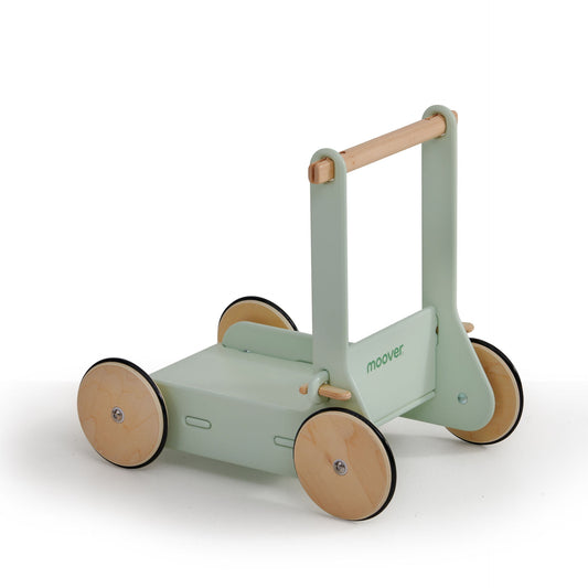 Children's green and wooden push cart on a white background